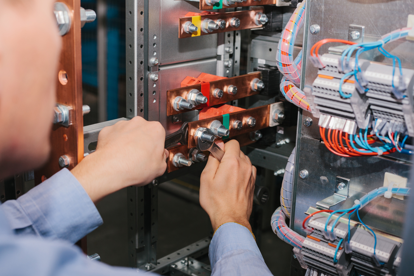 Electrician near the low-voltage cabinet. Uninterrupted power supply. Electricity.